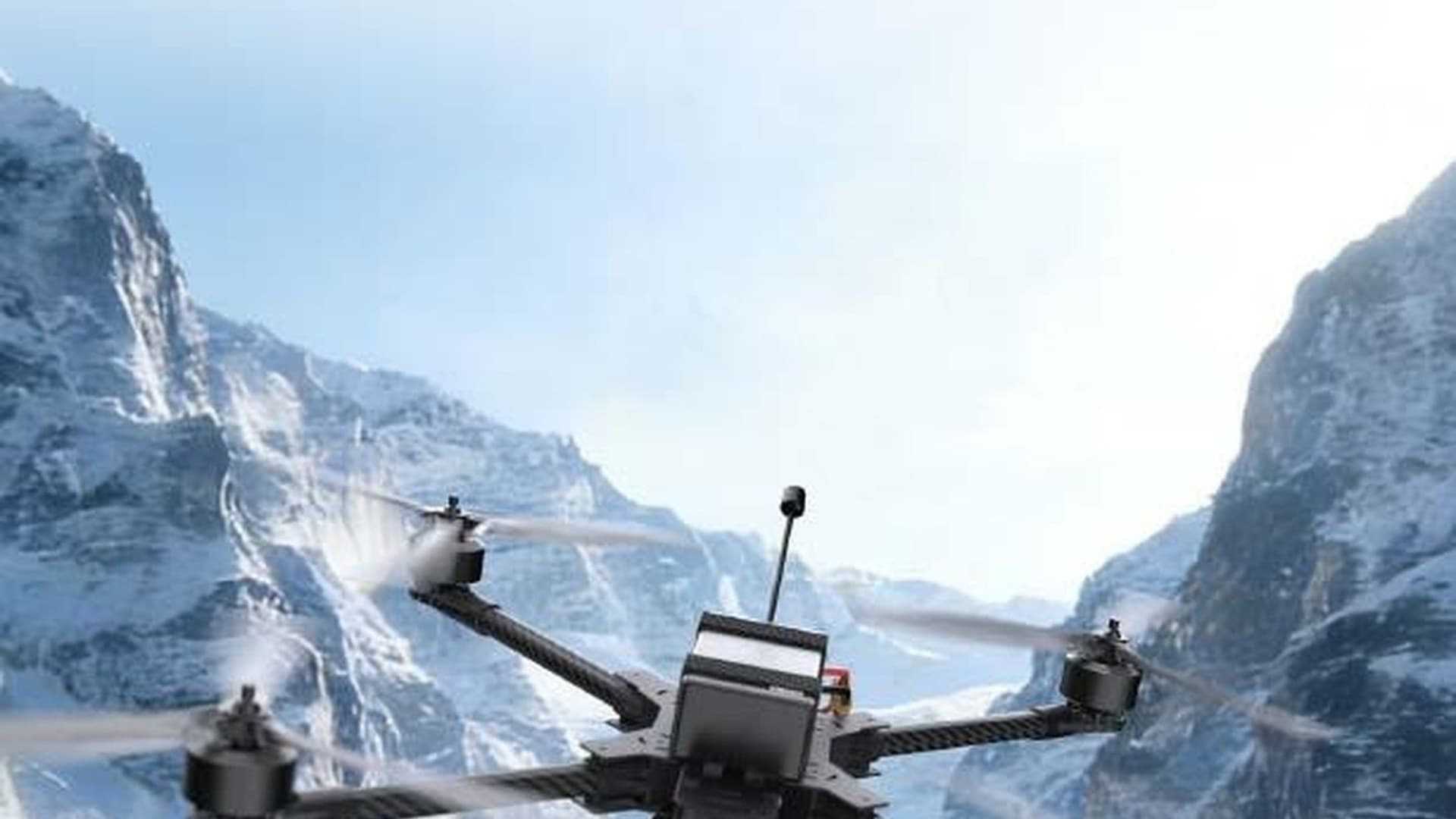 Cyron R-series responder FPV drone in flight through a snow-mountain corridor.